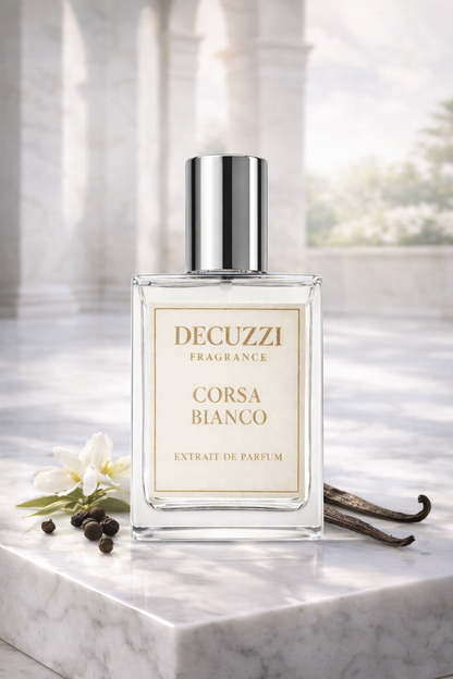 Decuzzi Fragrance Corsa Bianco perfume bottle on a marble surface with vanilla beans and flowers.